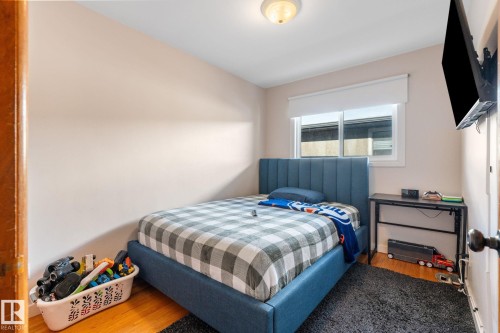 Bedroom featuring wood finished floors - 9847 79 Street, Edmonton, AB - Indoor Photo Showing Bedroom