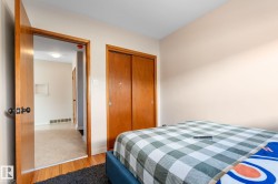 Bedroom with wood finished floors and a closet - 