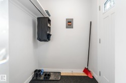 Laundry area with baseboards and electric panel - 