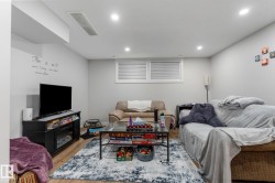 Living room with wood finished floors and recessed lighting - 