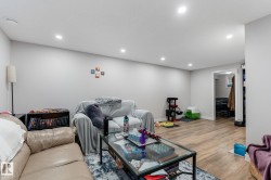 Living area featuring light wood finished floors and recessed lighting - 