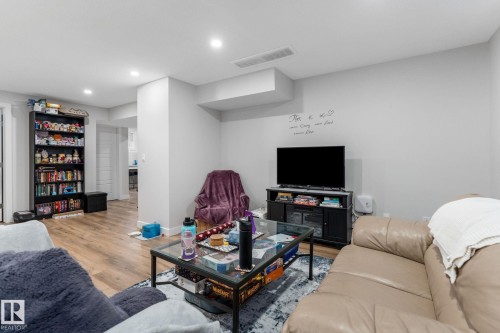 Living room featuring wood finished floors and recessed lighting - 9847 79 Street, Edmonton, AB - Indoor
