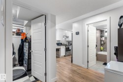 Corridor featuring light wood finished floors - 