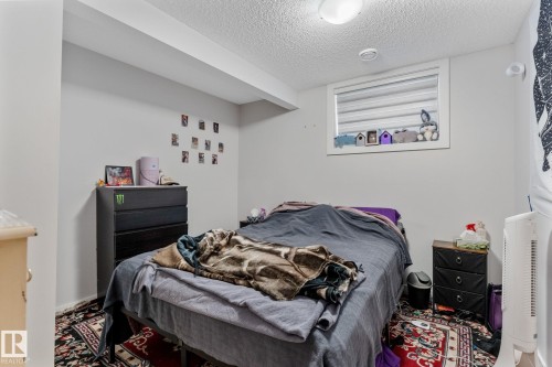 Bedroom with a textured ceiling - 9847 79 Street, Edmonton, AB - Indoor Photo Showing Bedroom