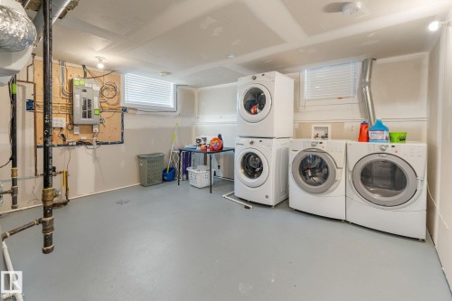 Laundry area with concrete floors, electric panel, and hookup for a washing machine - 9847 79 Street, Edmonton, AB - Indoor Photo Showing Laundry Room