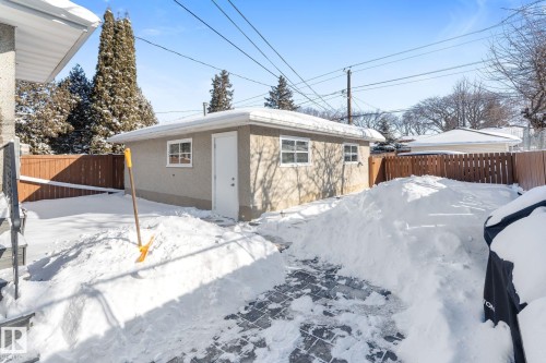 Rear view of property with a fenced backyard and an outbuilding - 9847 79 Street, Edmonton, AB - Outdoor