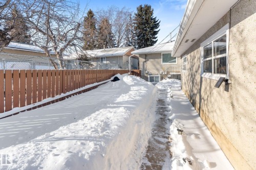 Yard covered in snow with a fenced backyard - 9847 79 Street, Edmonton, AB - Outdoor