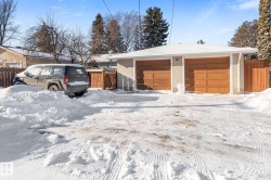View of front of home with an outdoor structure and a detached garage - 