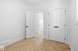 Unfurnished bedroom featuring parquet floors and a closet - 