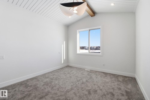 Empty room with carpet floors and beam ceiling - 90 Eldridge Point(E), St. Albert, AB - Indoor Photo Showing Other Room