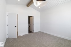 Unfurnished bedroom with light colored carpet, ensuite bath, recessed lighting, and ceiling fan - 