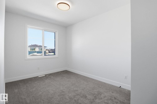 Spare room featuring carpet flooring and baseboards - 90 Eldridge Point(E), St. Albert, AB - Indoor Photo Showing Other Room