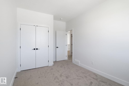 Unfurnished bedroom featuring light carpet and a closet - 90 Eldridge Point(E), St. Albert, AB - Indoor Photo Showing Other Room