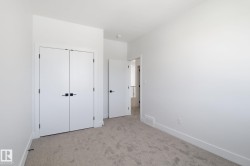 Unfurnished bedroom featuring light carpet and a closet - 