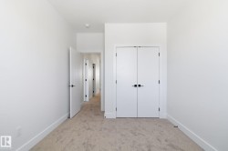 Unfurnished bedroom with light carpet and a closet - 