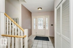 Entryway with light tile patterned floors and a textured ceiling - 