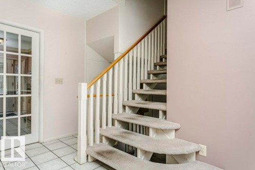 Stairs featuring tile patterned floors and baseboards - 6304 131 Street, Edmonton, AB - Indoor Photo Showing Other Room