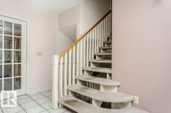 Stairs featuring tile patterned floors and baseboards - 