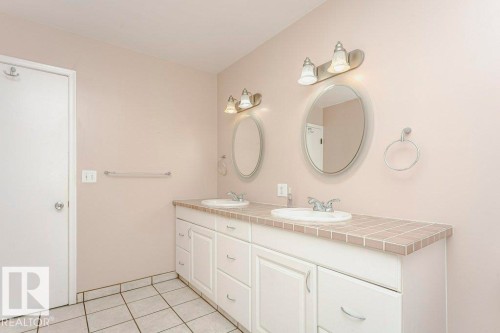 Full bathroom featuring double vanity and light tile patterned floors - 6304 131 Street, Edmonton, AB - Indoor Photo Showing Bathroom