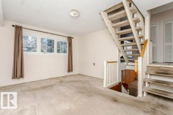 Stairs featuring carpet flooring and a textured ceiling - 