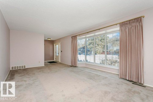 Carpeted spare room with a textured ceiling and baseboards - 6304 131 Street, Edmonton, AB - Indoor Photo Showing Other Room