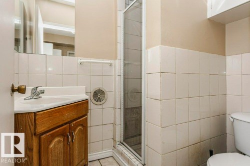 Full bath featuring vanity, a shower stall, and tile walls - 6304 131 Street, Edmonton, AB - Indoor Photo Showing Bathroom