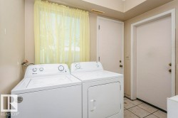 Laundry area featuring washer and clothes dryer and light tile patterned floors - 