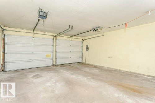 Garage featuring a garage door opener and electric panel - 6304 131 Street, Edmonton, AB - Indoor Photo Showing Garage