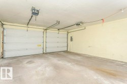 Garage featuring a garage door opener and electric panel - 