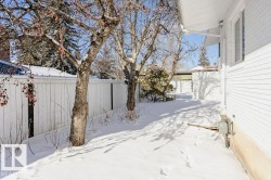 Yard layered in snow with a fenced backyard - 