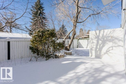 Yard covered in snow with a fenced backyard - 6304 131 Street, Edmonton, AB - Outdoor