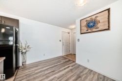 Unfurnished dining area featuring light wood-type flooring and a textured ceiling - 