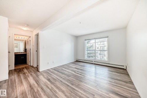 Spare room with a baseboard heating unit and light wood-style floors - 306 1188 Hyndman Road, Edmonton, AB - Indoor Photo Showing Other Room