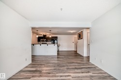 Unfurnished living room with dark wood-style floors and a textured ceiling - 