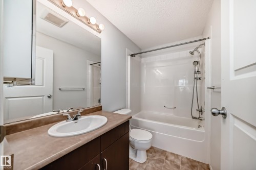Full bath featuring vanity, a textured ceiling, and tub / shower combination - 306 1188 Hyndman Road, Edmonton, AB - Indoor Photo Showing Bathroom