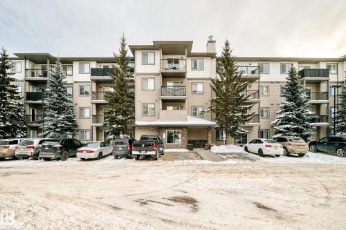 View of apartment building / complex featuring uncovered parking - 306 1188 Hyndman Road, Edmonton, AB - Outdoor With Balcony With Facade