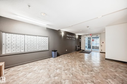 Common area featuring a textured wall and heating unit - 306 1188 Hyndman Road, Edmonton, AB - Indoor Photo Showing Other Room