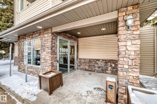 Entrance to property with stone siding - 306 1188 Hyndman Road, Edmonton, AB - Outdoor With Exterior