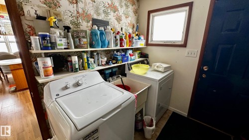 Laundry area with dark wood-type flooring and independent washer and dryer - 52012 Hwy 21, Rural Strathcona County, AB - Indoor Photo Showing Laundry Room