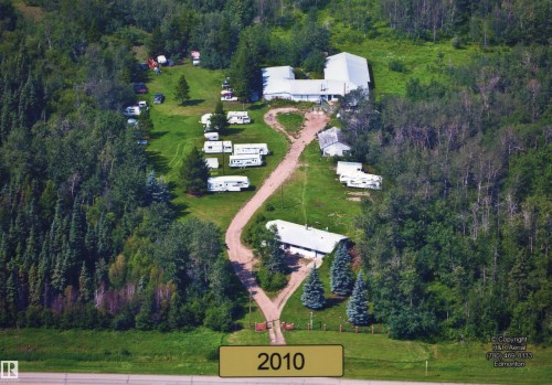 View of property location featuring a forest. Taken in 2010. The one storage shed no longer exists. - 52012 Hwy 21, Rural Strathcona County, AB - Outdoor With View