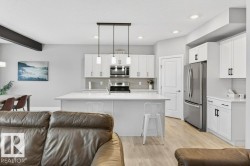 View from the expansive open-to-below great room looking into the large, open kitchen area. - 
