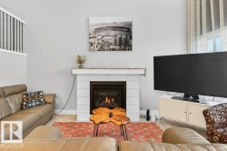 Open-to-below great room flanked by huge windows looking out over the deck and to the pond + the vast open staircase leading to the second floor. - 