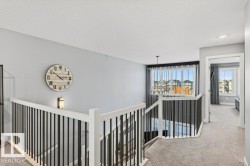 Corridor and landing on second floor - looking towards the back of the home with the open-to-below space. - 