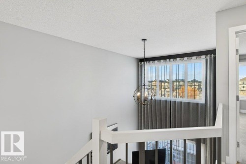 Detailed view of a textured ceiling and a chandelier - 1909 Davidson Wynd, Edmonton, AB - Indoor Photo Showing Other Room