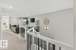 Upstairs landing - view from primary bedroom doorway to open-to-below great room and bonus room. - 