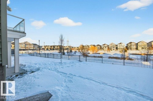 Yard layered in snow featuring a residential view and a balcony - 1909 Davidson Wynd, Edmonton, AB - Outdoor
