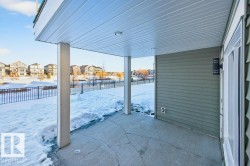 Covered walkout patio under main floor deck. - 