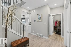 View from front foyer towards hallway leading to mudroom and walkthrough pantry - 