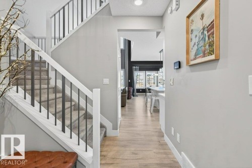 Sweeping views into bright kitchen, great room, and stairwell to the second floor. - 1909 Davidson Wynd, Edmonton, AB - Indoor Photo Showing Other Room