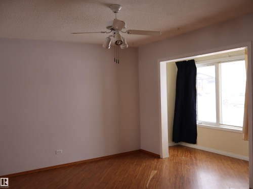 Spare room featuring light wood-style floors, a ceiling fan, and a textured ceiling - 5109 55 Street, Barrhead, AB - Indoor Photo Showing Other Room